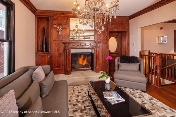 a living room with furniture and a chandelier