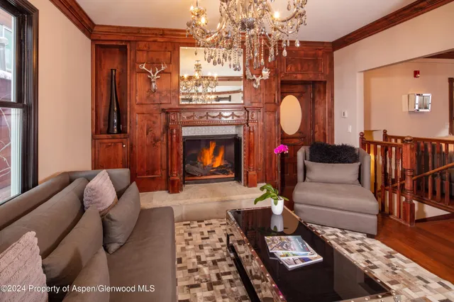 a living room with furniture and a chandelier