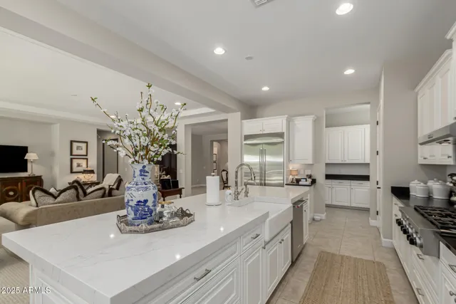 a kitchen with sink stove and refrigerator
