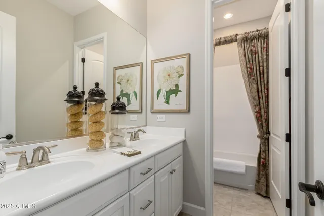 a bathroom with a double vanity sink mirror and shower
