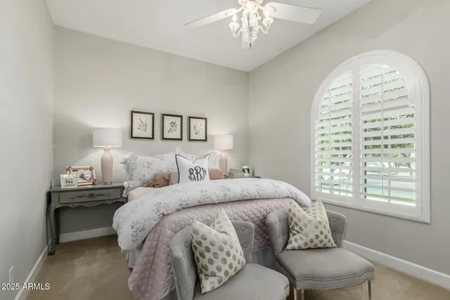 a bed sitting in a bedroom next to a window