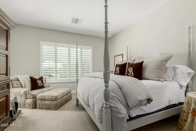 a bedroom with a bed and a couch