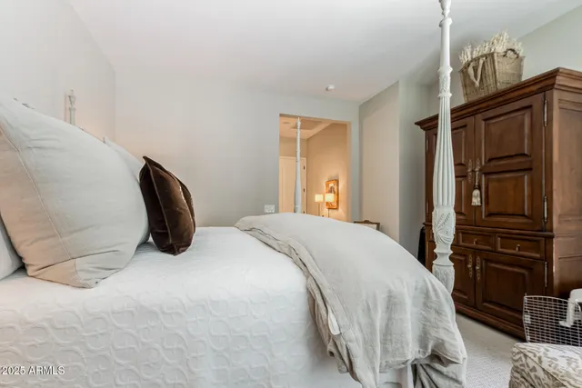 a bedroom with a bed and cabinets