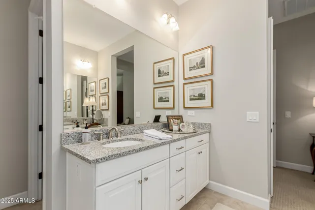 a bathroom with double sink and a mirror