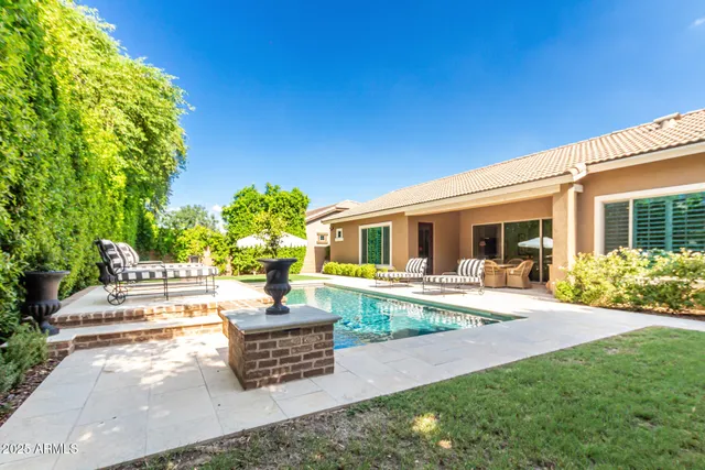 a view of a house with backyard sitting area and garden
