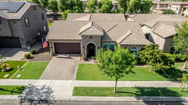 a aerial view of a house with a yard and potted plants