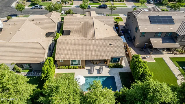 an aerial view of a house with swimming pool and patio