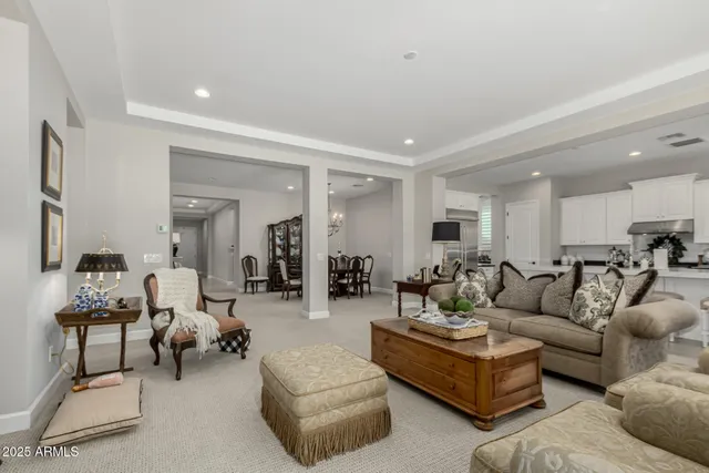 a living room with furniture and view of kitchen