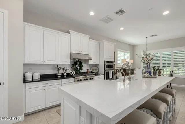 a kitchen with counter top space a sink cabinets and appliances