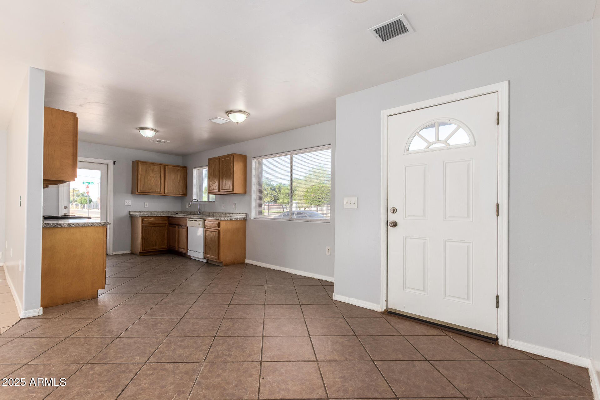 105 West 8th Street Eloy, AZ 85131 - Photo 12 of 31 a open kitchen with stainless steel appliances granite countertop a refrigerator and a sink