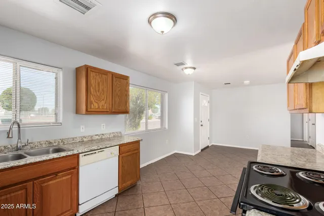 a kitchen with a sink stove and cabinets