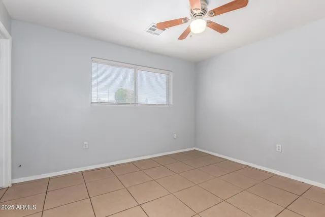 a view of a room with window and a ceiling fan