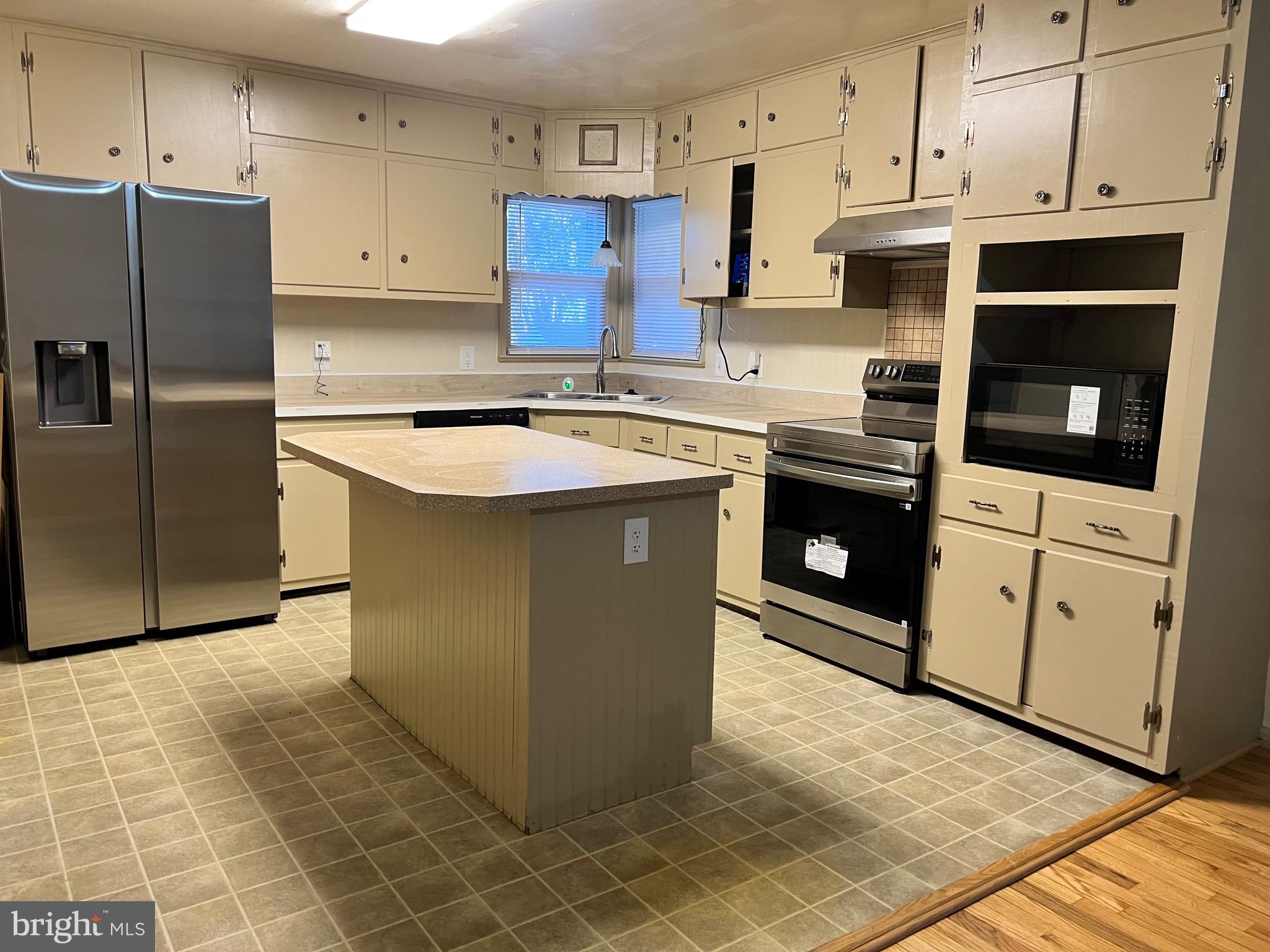 5700 Harrison Road Fredericksburg, VA 22407 - Photo 12 of 29 a kitchen with stainless steel appliances granite countertop a stove a refrigerator and a cabinets