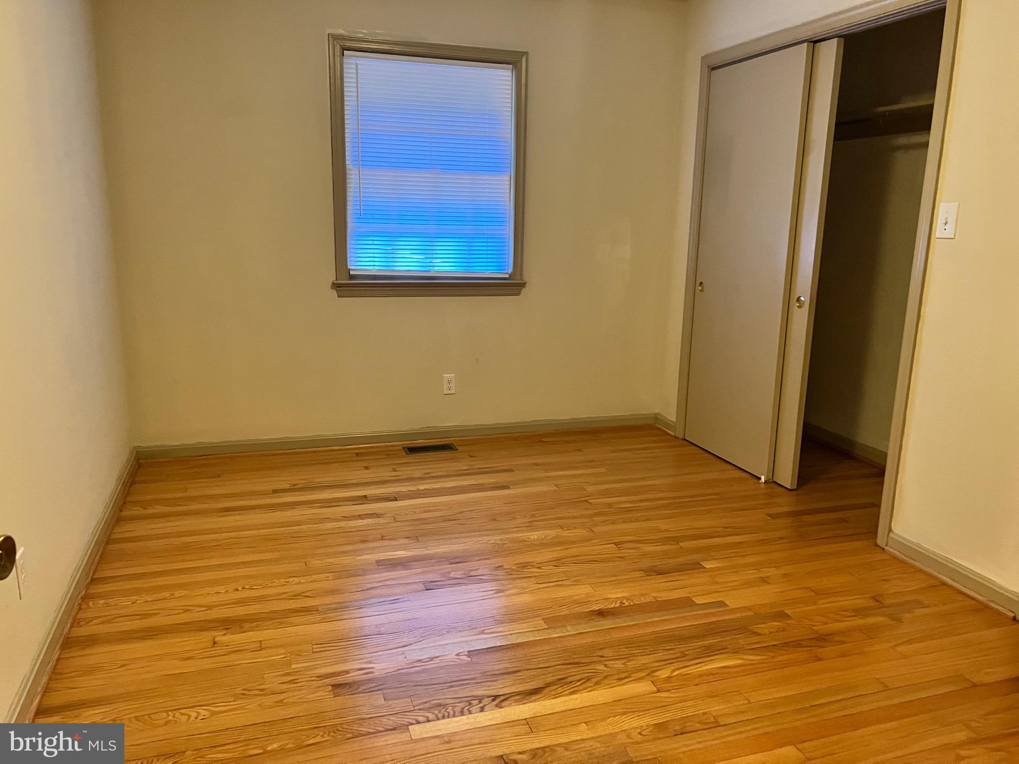 5700 Harrison Road Fredericksburg, VA 22407 - Photo 16 of 29 a view of an empty room with wooden floor and a window