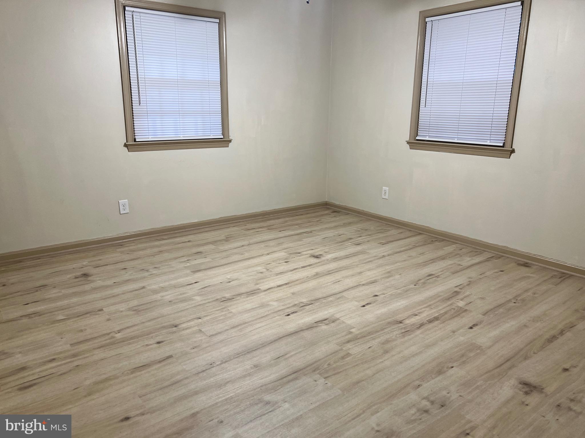 5700 Harrison Road Fredericksburg, VA 22407 - Photo 18 of 29 an empty room with wooden floor and windows