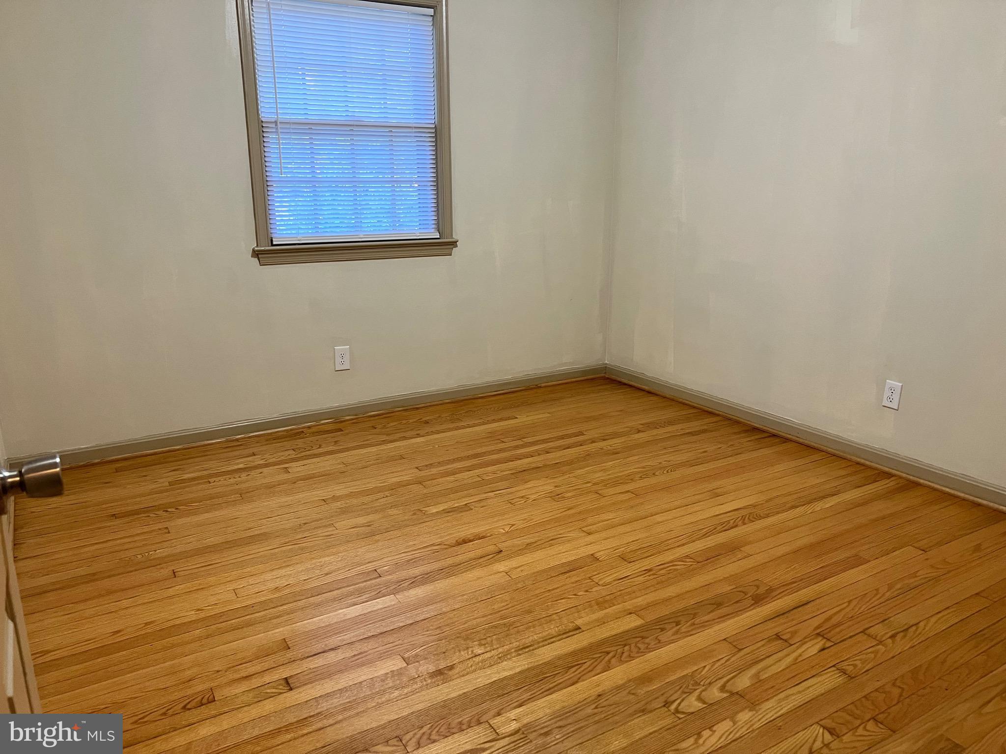 5700 Harrison Road Fredericksburg, VA 22407 - Photo 21 of 29 an empty room with wooden floor and windows