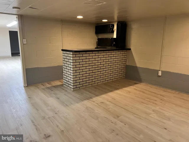 a view of a room with wooden floor