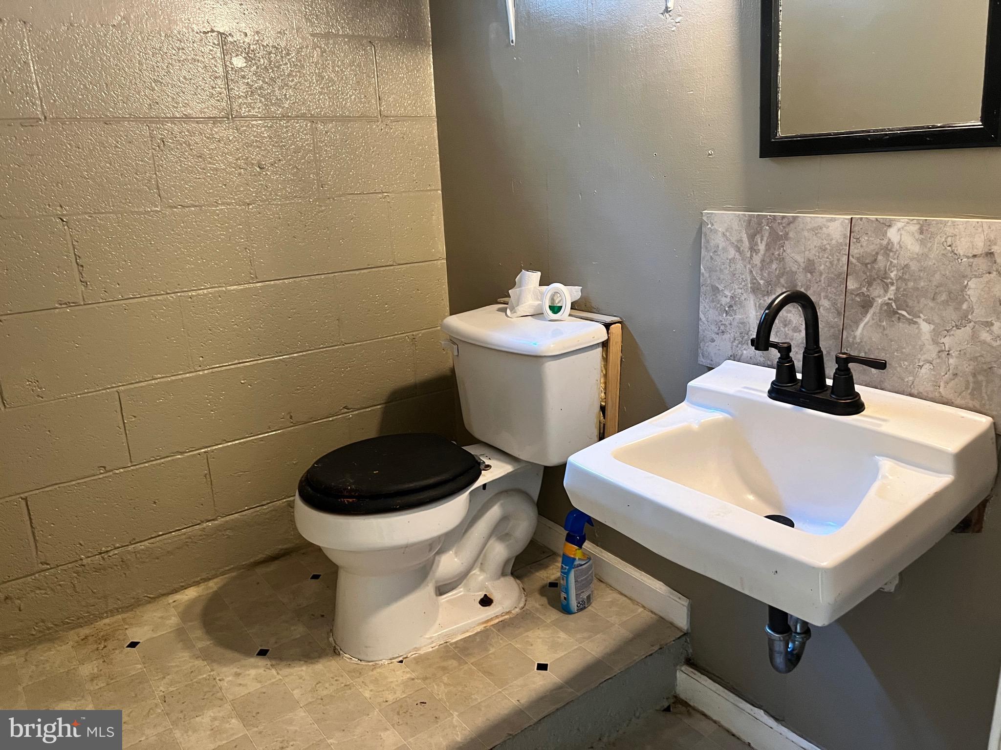 5700 Harrison Road Fredericksburg, VA 22407 - Photo 28 of 29 a bathroom with a sink toilet and a mirror