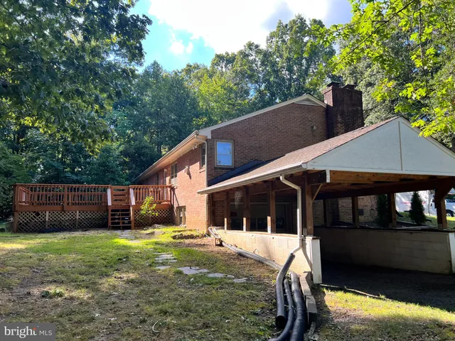 a view of a house with a yard and a garden