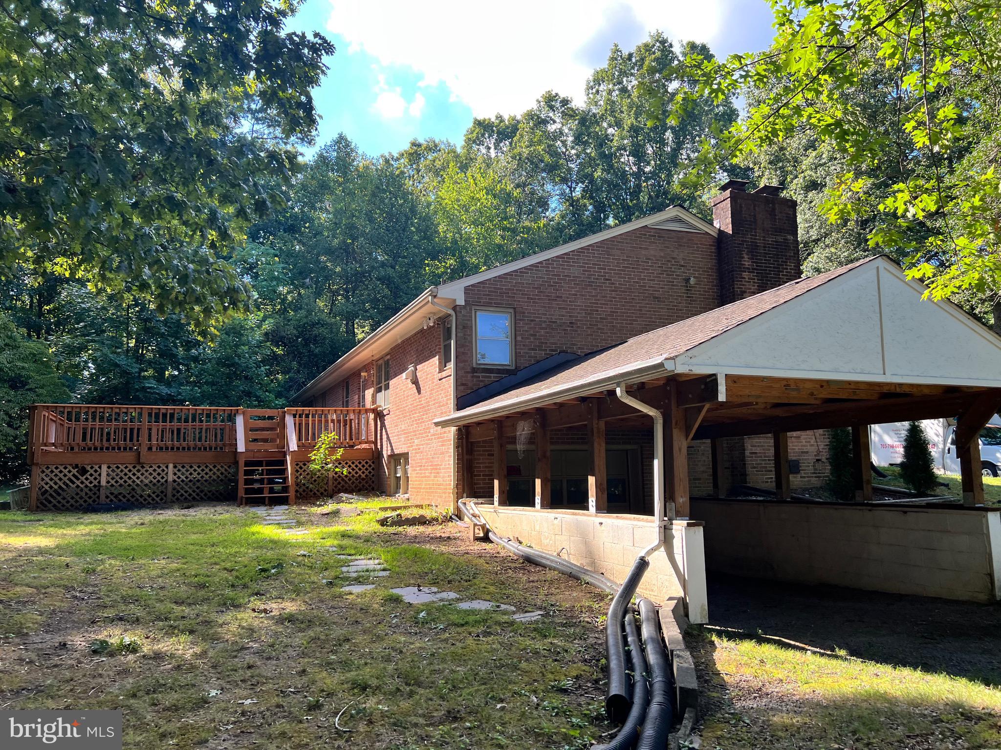 5700 Harrison Road Fredericksburg, VA 22407 - Photo 6 of 29 a view of a house with a yard and a garden