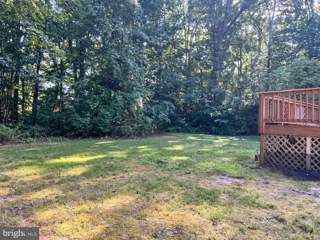 a view of a livingroom with wooden floor and window