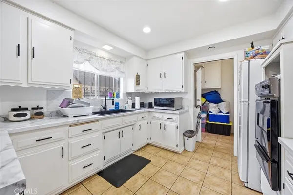 a kitchen with sink cabinets and appliances