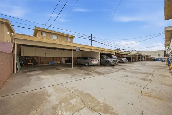 a view of parking space with a car parked in front of it