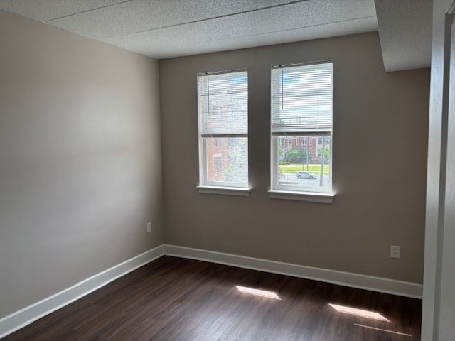 34 Sumner Avenue, Unit 302 Springfield, MA 01108 - Photo 4 of 6 a view of an empty room with wooden floor and a window