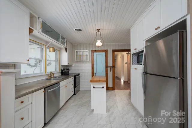 a kitchen with a refrigerator a sink and dishwasher