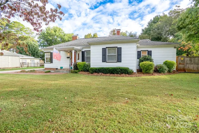 a front view of house with yard and green space