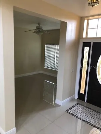 a view of an empty room with a fireplace and a window