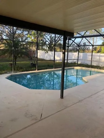 a view of swimming pool with a yard