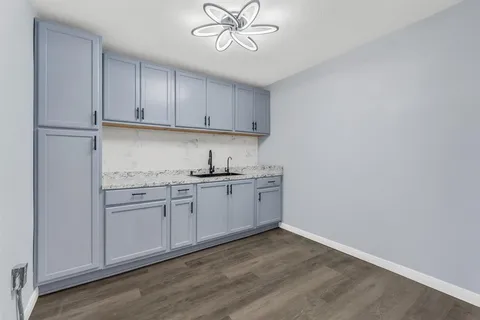 a kitchen with granite countertop cabinets stainless steel appliances and a sink