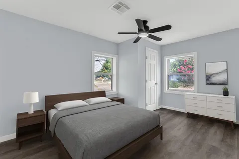 a bedroom with a large bed and a window