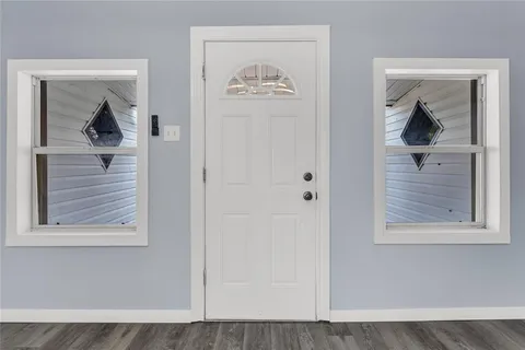 a view of a hallway with a small closet