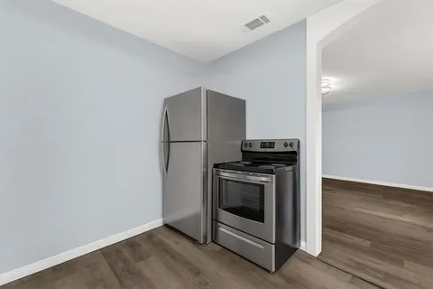 a kitchen with a stove and a refrigerator