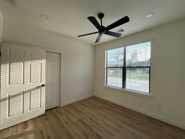 a view of a livingroom with a ceiling fan and window