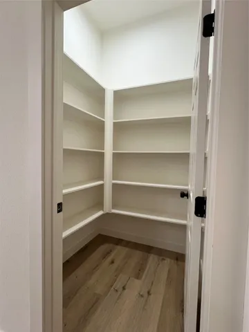 a view of a room with wooden floor