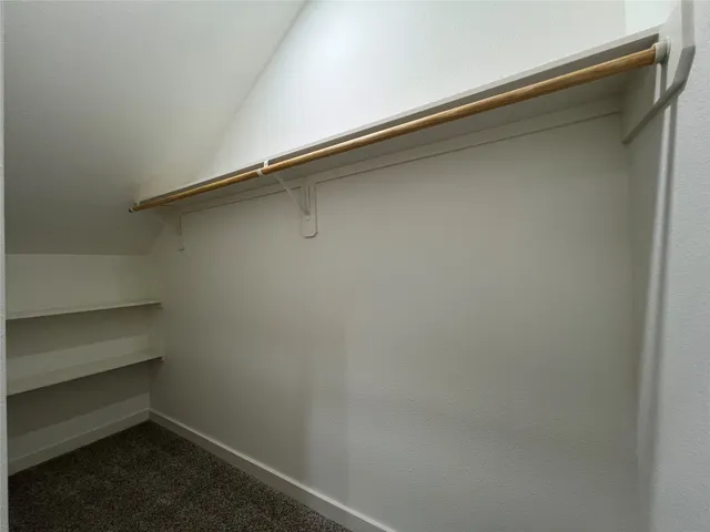 a view of a livingroom with a ceiling fan and window