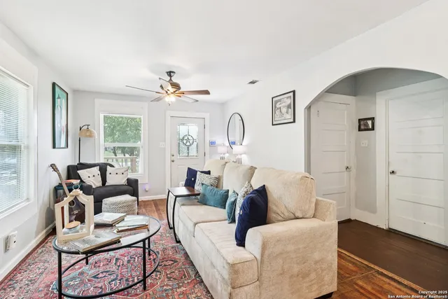 a living room with furniture and wooden floor