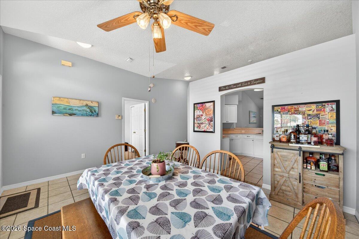 5975 Aruin Street Cocoa, FL 32927 - Photo 8 of 70 a bedroom with a bed and a flat tv screen on dresser