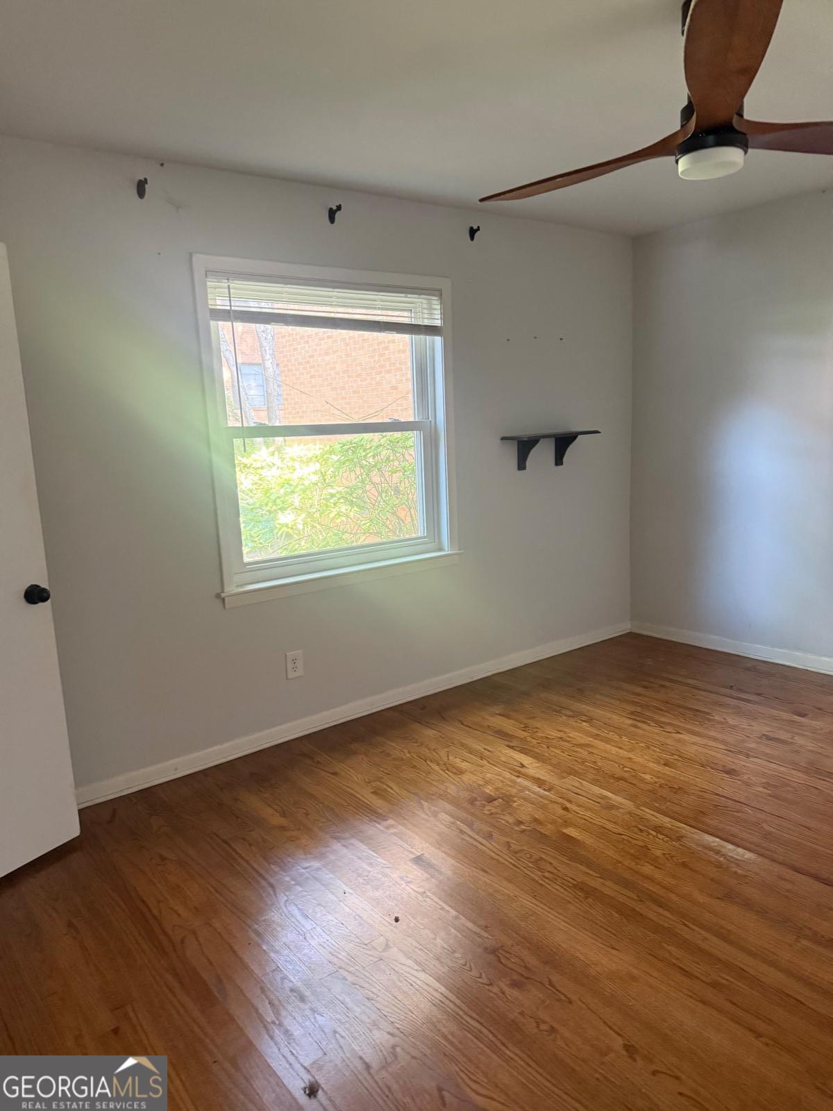 3510 Roswell Road, Unit H1 Atlanta, GA 30326 - Photo 33 of 43 an empty room with wooden floor and windows