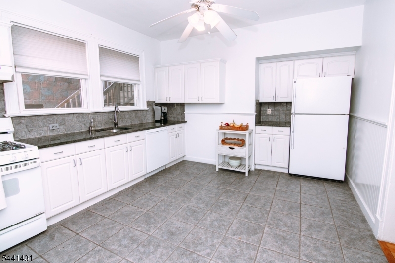 306 Springfield Avenue, Unit 1 Summit, NJ 07901 - Photo 10 of 17 a kitchen with granite countertop a sink cabinets stainless steel appliances and a window