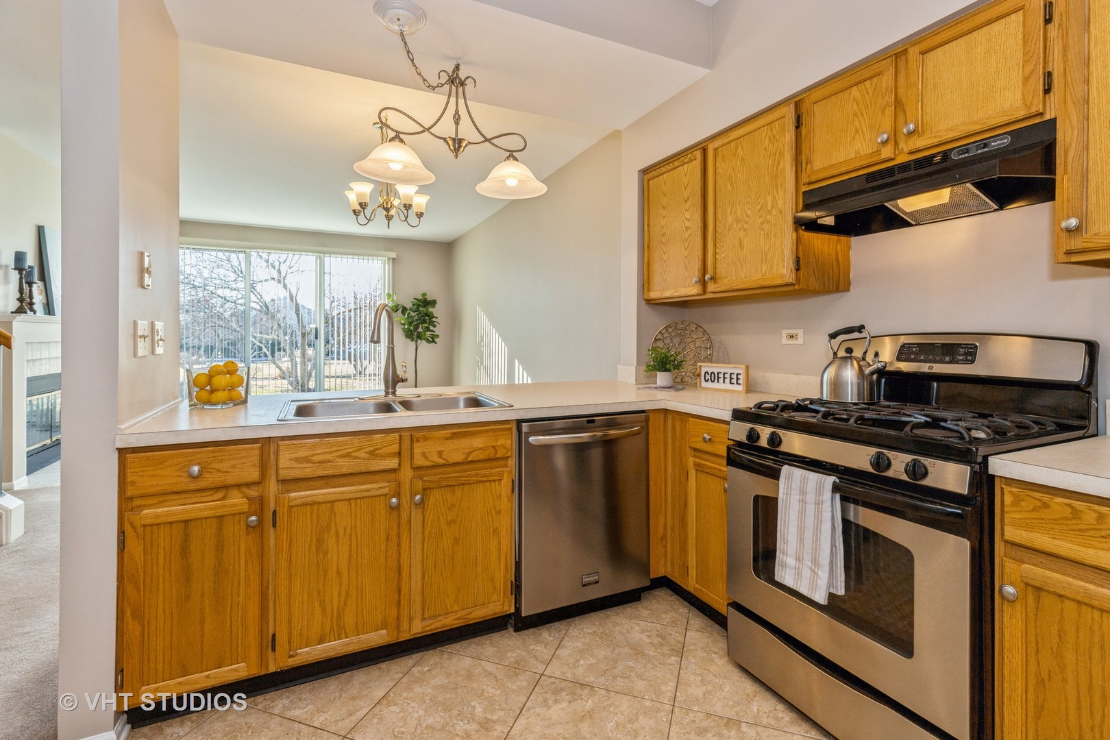 17896 Braewick Road Gurnee, IL 60031 - Photo 4 of 18 a kitchen with stainless steel appliances granite countertop a stove a sink and a microwave