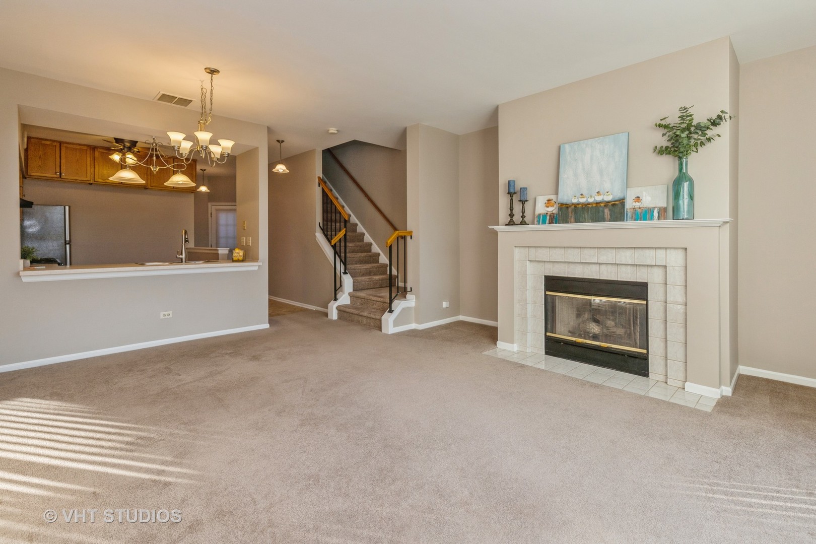 17896 Braewick Road Gurnee, IL 60031 - Photo 8 of 18 a view of a livingroom with a fireplace and chandelier
