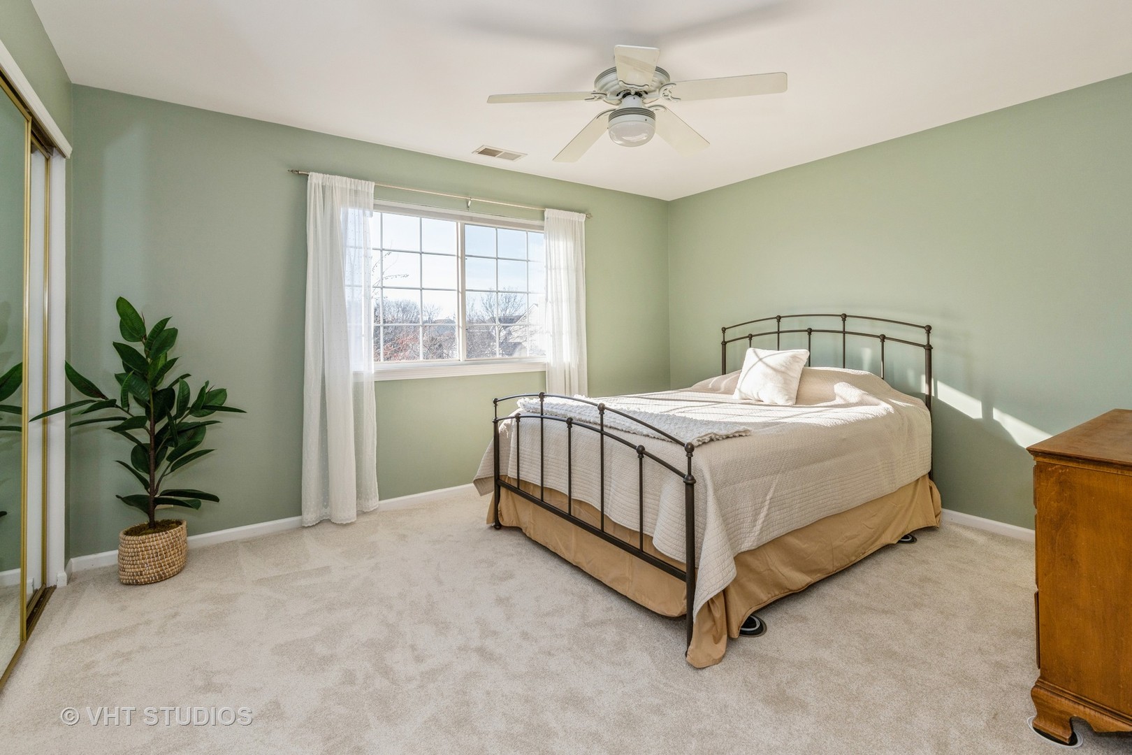 17896 Braewick Road Gurnee, IL 60031 - Photo 10 of 18 a bedroom with a bed and a potted plant