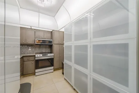 a kitchen with stainless steel appliances granite countertop a sink a stove and cabinets