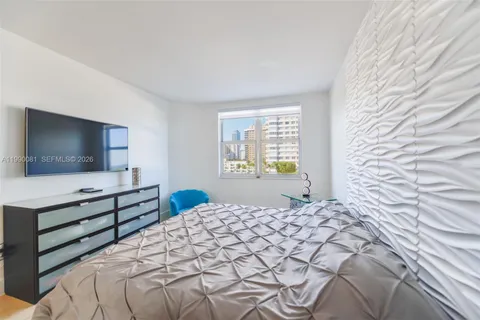 a bedroom with a bed and walk in closet