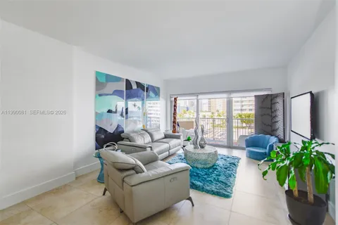 a living room with furniture flowers and a table