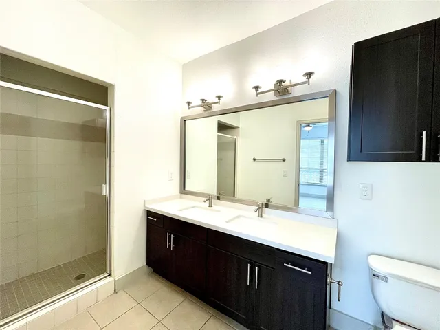 a bathroom with a double vanity sink and mirror